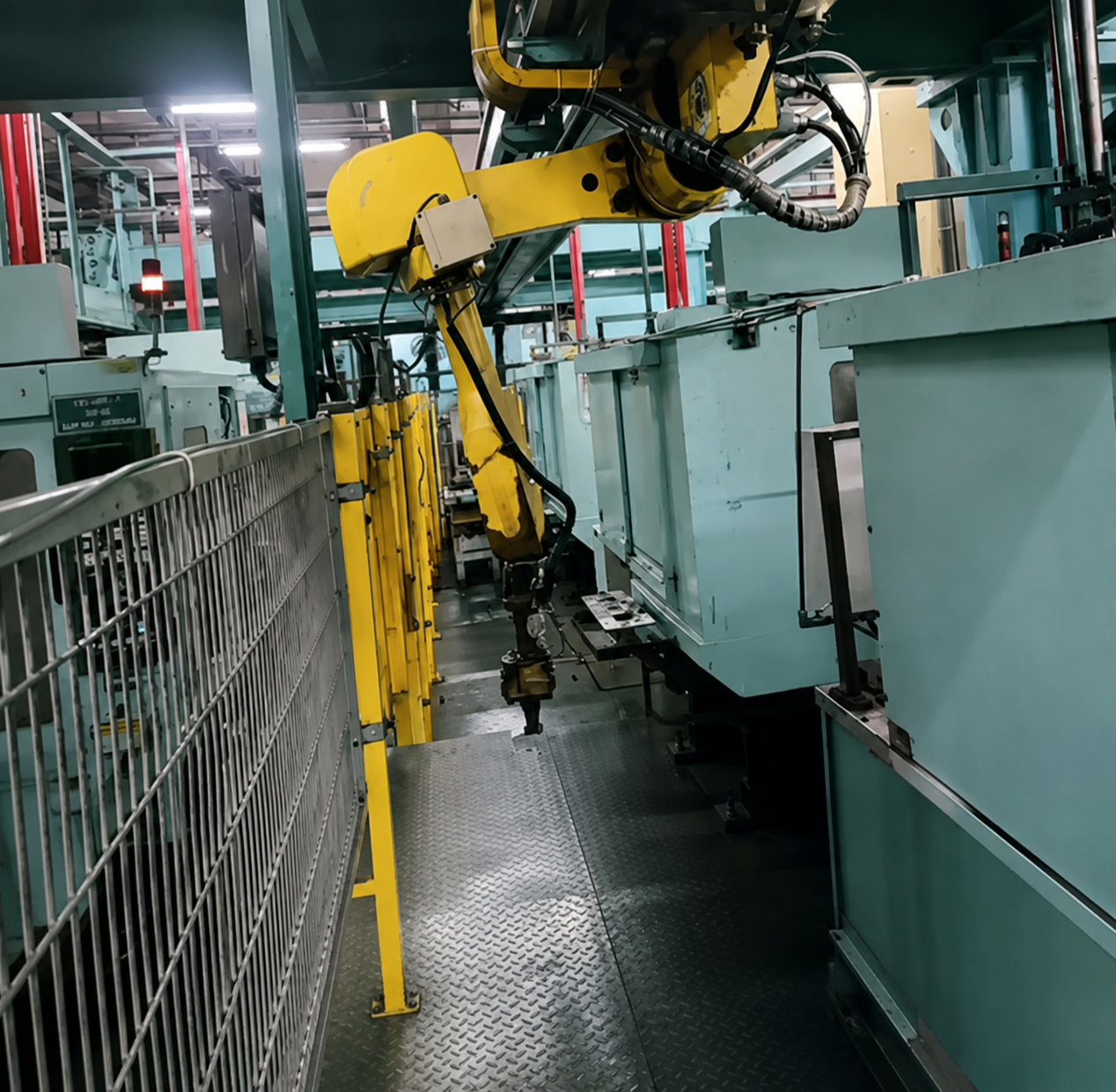 Industrial robotic arm in an automated cell